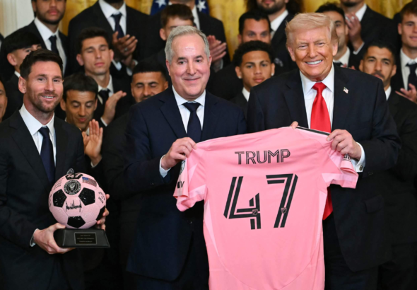 Lionel Messi and Inter Miami players standing with US President Donald Trump during a White House ceremony celebrating their 2025 MLS Cup triumph.